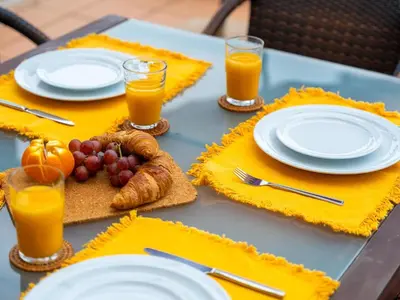 a table with plates and glasses of orange juice and fruit at Sunshine House by Stay ici Algarve Holiday Rental in Albufeira