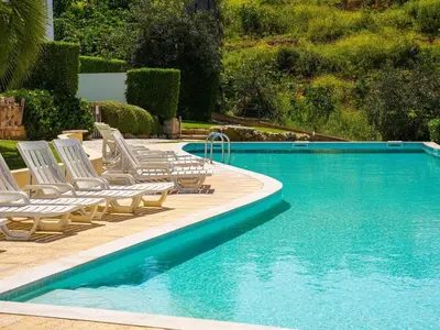 a swimming pool with lounge chairs and a swimming pool at Serenity 09 House by Stay ici Algarve Holiday Rental in Albufeira