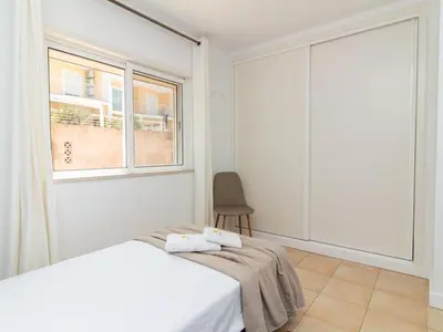 a white bedroom with a bed and a window at Serenity 09 House by Stay ici Algarve Holiday Rental in Albufeira