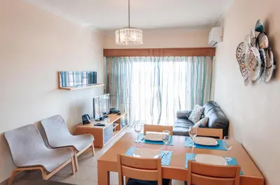 a living room with a table and a couch at Sea Blue - Frente ao Mar in Quarteira