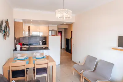 a kitchen and dining room with a table and chairs at Sea Blue - Frente ao Mar in Quarteira