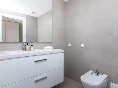 a white bathroom with a sink and a toilet at Green 3 Apartment by Stay ici Algarve Holiday Rental in Albufeira