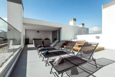 a white bedroom with a blue bed in it at Penthouse Isabela VistaMar - Rooftop & Jacuzzi in Albufeira
