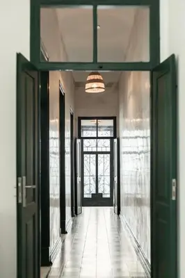 an empty hallway with a door and a window at Casa Dona Vitória in Faro