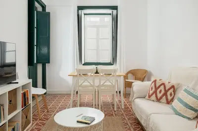 a living room with a couch and a table at Casa Dona Vitória in Faro