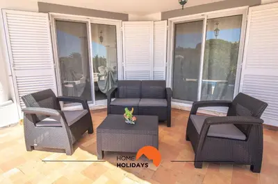 a porch with three chairs and a couch and a table at #297 Espaçosa Vivenda V5 by Home Holidays in Albufeira