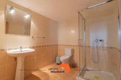 a bathroom with a shower and a sink and a toilet at #297 Espaçosa Vivenda V5 by Home Holidays in Albufeira