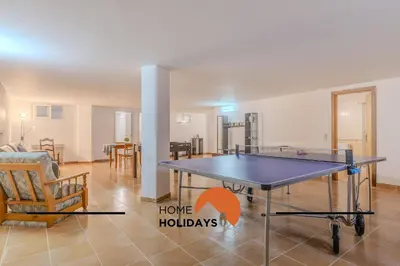a ping pong table in the middle of a living room at #297 Espaçosa Vivenda V5 by Home Holidays in Albufeira