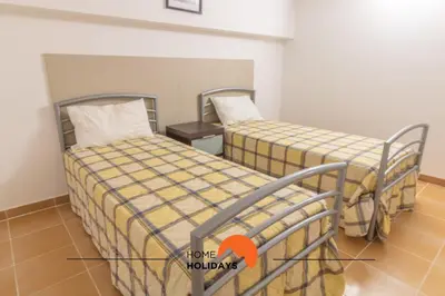 two beds in a small room with an orange arrow pointing to a room at #297 Espaçosa Vivenda V5 by Home Holidays in Albufeira