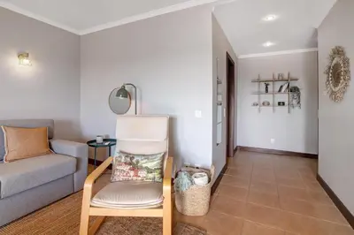 a living room with a couch and a chair at Sunrise Salgados Village in Galé