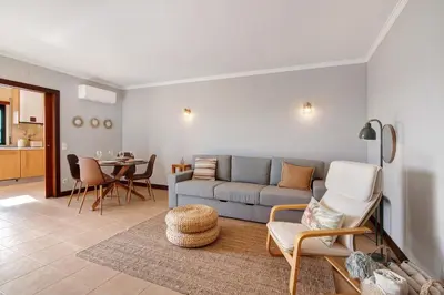 a living room with a couch and a table at Sunrise Salgados Village in Galé