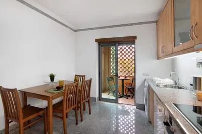 a kitchen and dining room with a table and chairs at Apart Condomínio do Vale in Guia