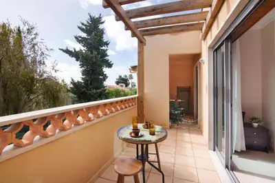 a balcony of a house with a table and chairs at Apart Condomínio do Vale in Guia