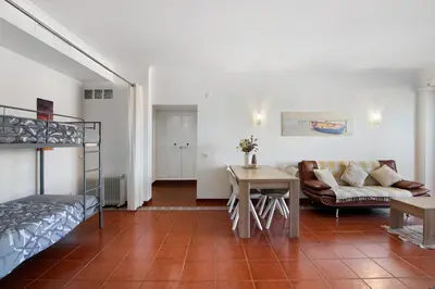 a living room with a couch and a table at Oura Beach Cozy Apartment in Albufeira