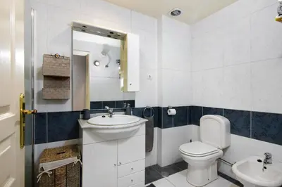 a bathroom with a toilet and a sink at Oura Beach Cozy Apartment in Albufeira