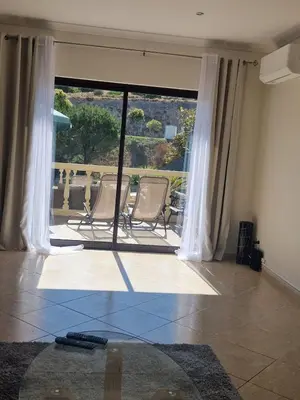a living room with two chairs and a large window at Holiday home in Albufeira in Albufeira