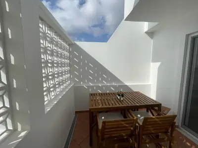 a room with a wooden table and two chairs at Casa da Baixa in Faro