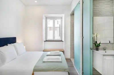 a small bedroom with a bed and a sink at Faro DAZ House by Get Your Stay in Faro