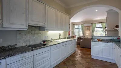 a large kitchen with white cabinets and a sink at 3Br Apt-Quinta do Lago-Private Terrace in Quinta do Lago