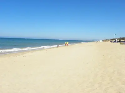 a group of people walking on the beach at 3Br Apt-Quinta do Lago-Private Terrace in Quinta do Lago