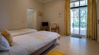 a bedroom with two beds and a sliding glass door at 3Br Apt-Quinta do Lago-Private Terrace in Quinta do Lago