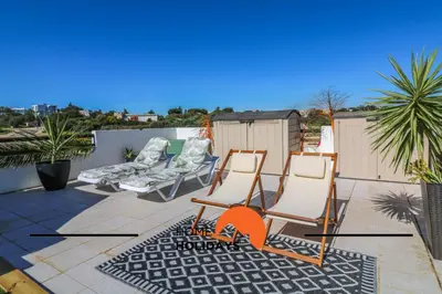 a patio with two chairs and a couple of chairs at #294 T2 Com Amplo Terraço by Home Holidays in Albufeira