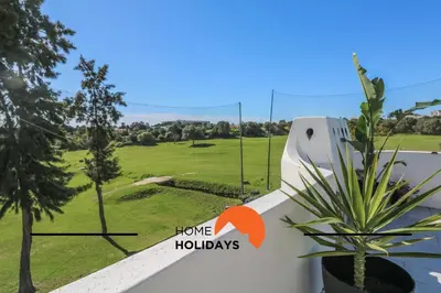 a view of a golf course from the balcony of a house at #294 T2 Com Amplo Terraço by Home Holidays in Albufeira