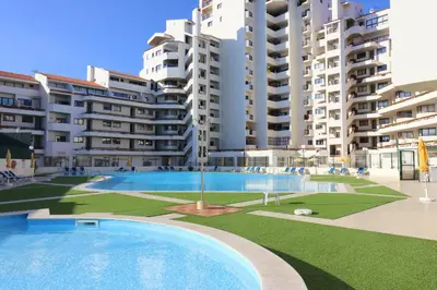 a large swimming pool in front of some apartment buildings at BeGuest Vila Magna Apartment in Albufeira