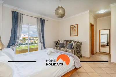 a bedroom with a large bed and a window at #298 Villas Luz H by Home Holidays in Albufeira