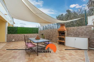 a patio with a table and chairs and a tent at #298 Villas Luz H by Home Holidays in Albufeira