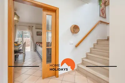 a home hallway with stairs and a home holidays sign at #298 Villas Luz H by Home Holidays in Albufeira
