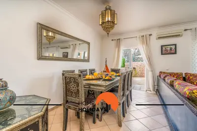 a dining room with a table and chairs and a mirror at #298 Villas Luz H by Home Holidays in Albufeira