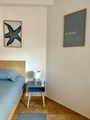 a bedroom with a bed and a starfish on the wall at Beach, please! in Quarteira