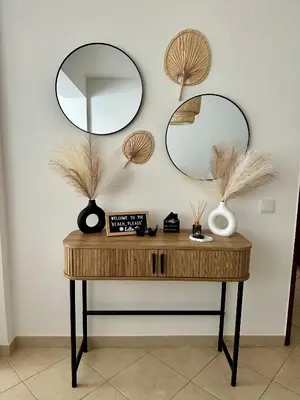 a table with two mirrors on a white wall at Beach, please! in Quarteira