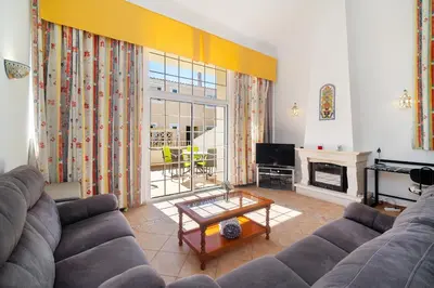 a bedroom with a large bed and a desk at Ponta Grande Resort - Villa Coral in Albufeira