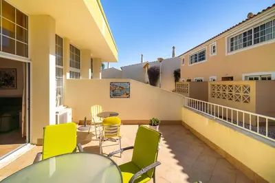 a white house with a gate and a door at Ponta Grande Resort - Villa Coral in Albufeira
