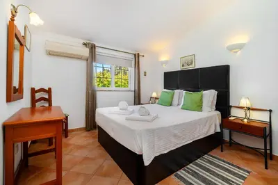 a living room with a couch and a fireplace at Ponta Grande Resort - Villa Coral in Albufeira