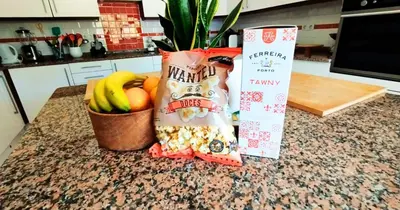 a counter with a bag of snacks and a bowl of fruit at Quinta Azul in Loulé