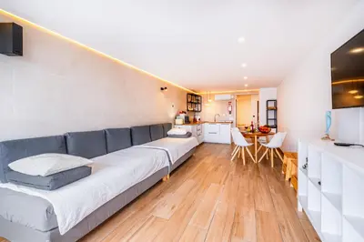 a living room with a couch and a kitchen at Sun&Sea in Albufeira
