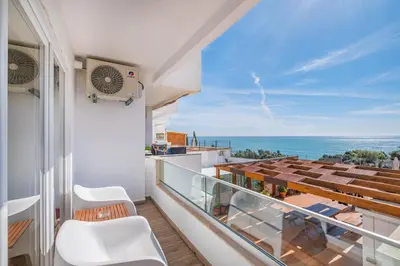 a balcony with chairs and a view of the ocean at Sun&Sea in Albufeira