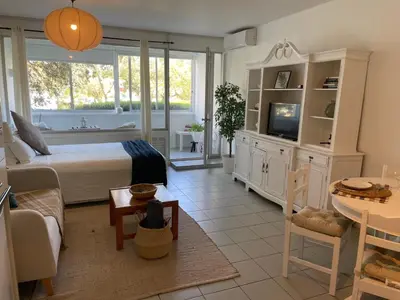 a bedroom with a bed and a living room at Casa Ligia in Vilamoura