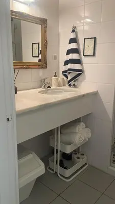 a bathroom with a sink and a mirror at Casa Ligia in Vilamoura