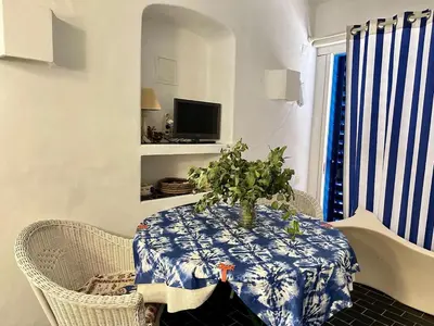 a table with a blue and white table cloth and a plant on it at Balaia Gardens in Albufeira in Albufeira