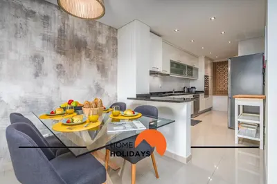 a kitchen and dining room with a dining table and chairs at #249 Sapphire Shoreline Lodge by Home Holidays in Albufeira