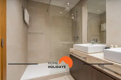 a bathroom with a sink and a shower with a mirror at #249 Sapphire Shoreline Lodge by Home Holidays in Albufeira