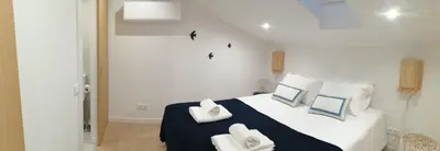 a bedroom with a bed with two pillows on it at Casa Corisca - stylish, cosy, top location in the heart of Faro in Faro
