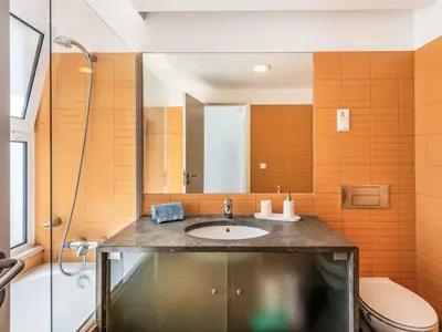 a bathroom with a sink and a toilet at Villa Maria, 3BD & Pool & Garden & BBQ in Albufeira