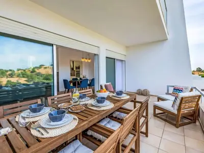 a dining room with a wooden table and chairs at Villa Maria, 3BD & Pool & Garden & BBQ in Albufeira