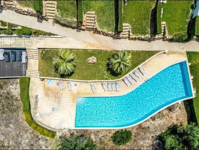 an overhead view of a swimming pool in a resort at Villa Maria, 3BD & Pool & Garden & BBQ in Albufeira