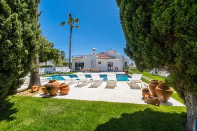 a group of vases sitting in front of a house at Villa Veiga - Luxury modern design with large beautiful garden in Albufeira